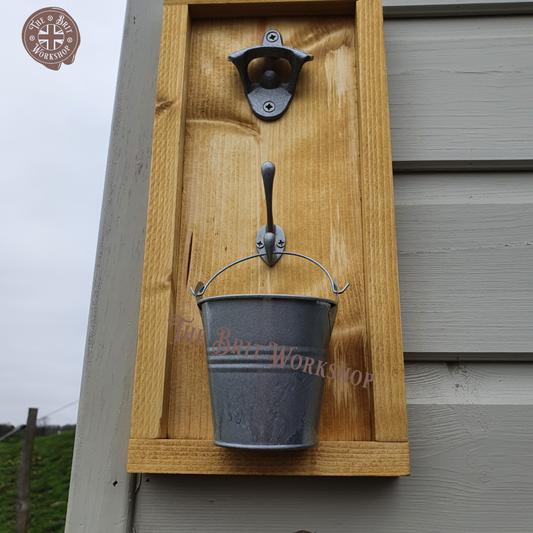 Wall mounted bottle opener with cap catcher bucket fixed to outside wall